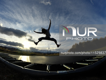 A little girl, Minudi Menulya, jumps on a trampoline in Twizel, New Zealand, on August 30, 2024. (