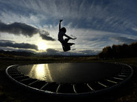 A little girl, Minudi Menulya, jumps on a trampoline in Twizel, New Zealand, on August 30, 2024. (