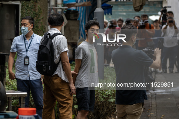 A man arrested by the National Security Police is seen during a police evidence gathering operation in Hong Kong, China, on August 31, 2024....