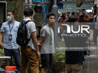 A man arrested by the National Security Police is seen during a police evidence gathering operation in Hong Kong, China, on August 31, 2024....