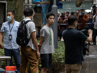 A man arrested by the National Security Police is seen during a police evidence gathering operation in Hong Kong, China, on August 31, 2024....