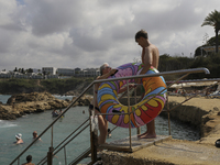 Tourists relax near a hotel near Paphos. Cyprus, Saturday, August 31, 2024. Today is the end of summer, but according to tour operators, hot...