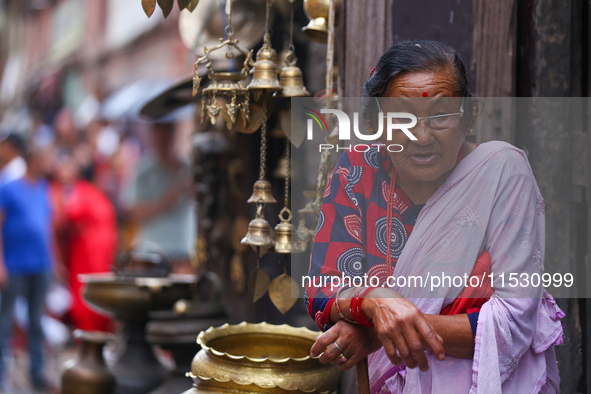 An elderly Nepali citizen watch the parade of statues of Dipankar Buddha during the Panchadan festival in Bhaktapur, Nepal on 31 August, 202...