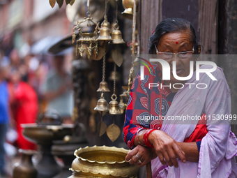 An elderly Nepali citizen watch the parade of statues of Dipankar Buddha during the Panchadan festival in Bhaktapur, Nepal on 31 August, 202...