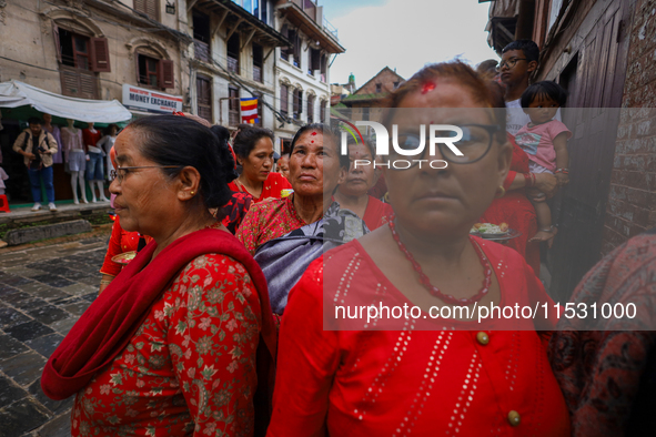 Nepali devotees watch the parade of statues of Dipankar Buddha during the Panchadan festival in Bhaktapur, Nepal, on August 31, 2024. On thi...