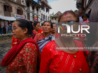 Nepali devotees watch the parade of statues of Dipankar Buddha during the Panchadan festival in Bhaktapur, Nepal, on August 31, 2024. On thi...