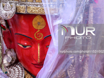 A statue of Dipankar Buddha is covered with plastic sheets after it rains during the annual Panchadan festival in Bhaktapur, Nepal, on Augus...