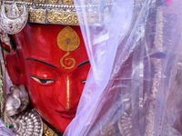 A statue of Dipankar Buddha is covered with plastic sheets after it rains during the annual Panchadan festival in Bhaktapur, Nepal, on Augus...