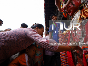 A Nepali devotee worships the statues of Dipankar Buddha during the Panchadan festival in Bhaktapur, Nepal, on August 31, 2024. On this day,...