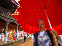 A Nepali devotee holds the umbrella for the statues of Dipankar Buddha during the Panchadan festival in Bhaktapur, Nepal, on August 31, 2024...