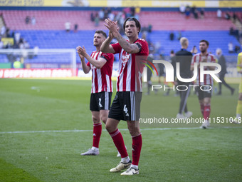 Tristan Crama #4 of Exeter City F.C. celebrates at full time during the Sky Bet League 1 match between Bolton Wanderers and Exeter City at t...