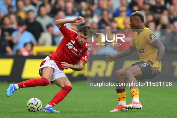 Neco Williams of Nottingham Forest is under pressure from Mario Lemina of Wolverhampton Wanderers during the Premier League match between No...