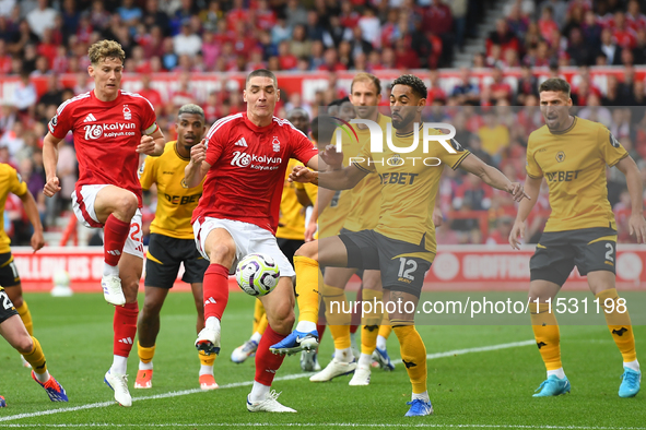 Nikola Milenkovic of Nottingham Forest battles for the ball with Matheus Cunha of Wolverhampton Wanderers during the Premier League match be...