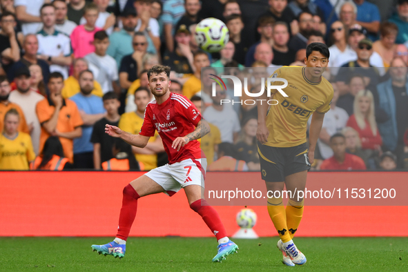 Neco Williams of Nottingham Forest clears the ball under pressure from Hwang Hee-Chan of Wolverhampton Wanderers during the Premier League m...