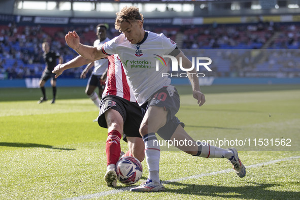 Dion Charles #10 of Bolton Wanderers F.C. tackles the opponent during the Sky Bet League 1 match between Bolton Wanderers and Exeter City at...