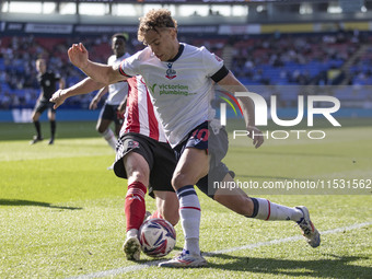 Dion Charles #10 of Bolton Wanderers F.C. tackles the opponent during the Sky Bet League 1 match between Bolton Wanderers and Exeter City at...