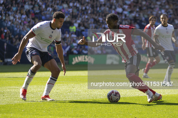 Millenic Alli #11 of Exeter City F.C. is in possession of the ball during the Sky Bet League 1 match between Bolton Wanderers and Exeter Cit...