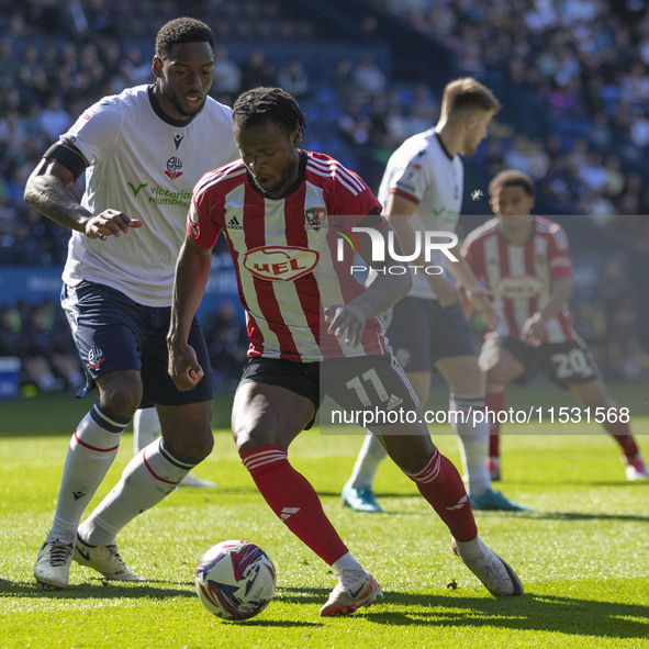 Millenic Alli #11 of Exeter City F.C. is in possession of the ball during the Sky Bet League 1 match between Bolton Wanderers and Exeter Cit...