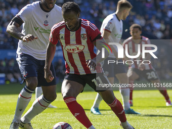 Millenic Alli #11 of Exeter City F.C. is in possession of the ball during the Sky Bet League 1 match between Bolton Wanderers and Exeter Cit...