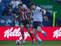 Jack Aitchison #10 of Exeter City F.C. is tackled by George Thomason #4 of Bolton Wanderers F.C. during the Sky Bet League 1 match between B...