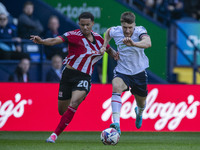 Jack Aitchison #10 of Exeter City F.C. is tackled by George Thomason #4 of Bolton Wanderers F.C. during the Sky Bet League 1 match between B...