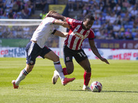 Millenic Alli #11 of Exeter City F.C. is tackled by Kyle Dempsey #22 of Bolton Wanderers F.C. during the Sky Bet League 1 match between Bolt...