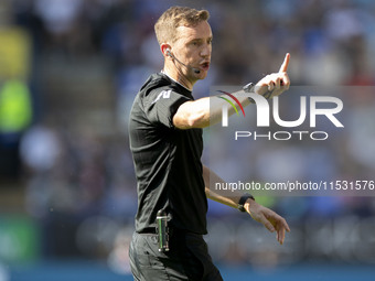 Referee Ben Toner gesticulates during the Sky Bet League 1 match between Bolton Wanderers and Exeter City at the Toughsheet Stadium in Bolto...