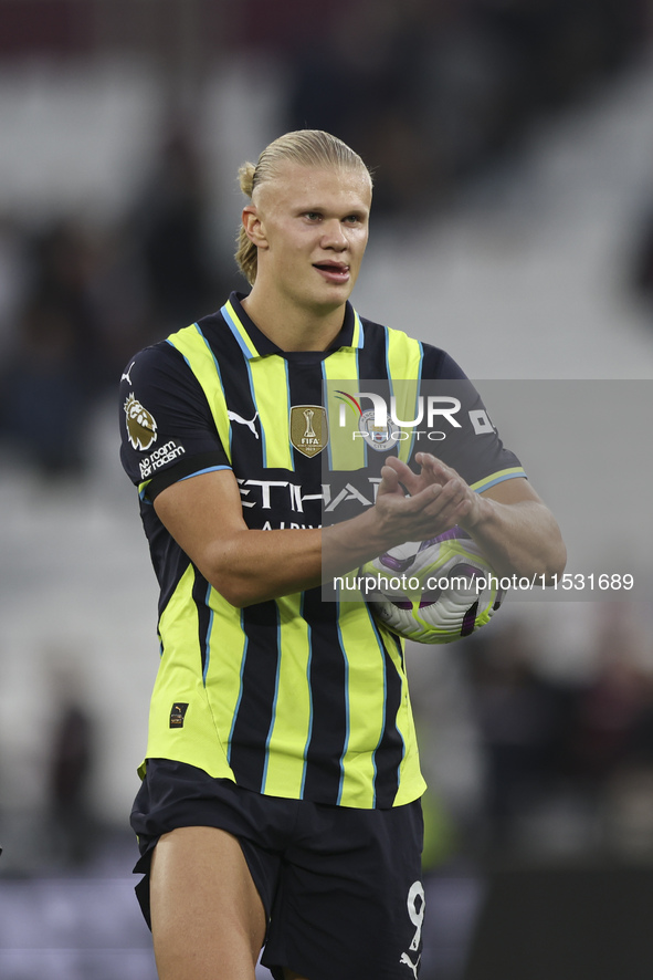 Erling Haaland of Manchester City with the match ball after scoring a hat trick during the Premier League match between West Ham United and...