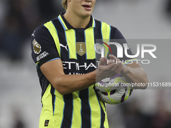 Erling Haaland of Manchester City with the match ball after scoring a hat trick during the Premier League match between West Ham United and...