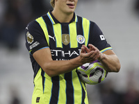 Erling Haaland of Manchester City with the match ball after scoring a hat trick during the Premier League match between West Ham United and...