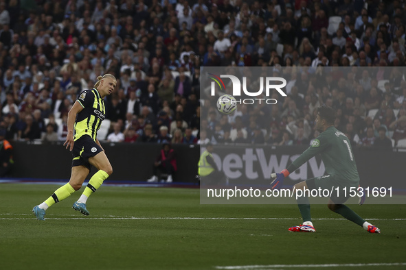 Erling Haaland of Manchester City scores his third goal during the Premier League match between West Ham United and Manchester City at the L...