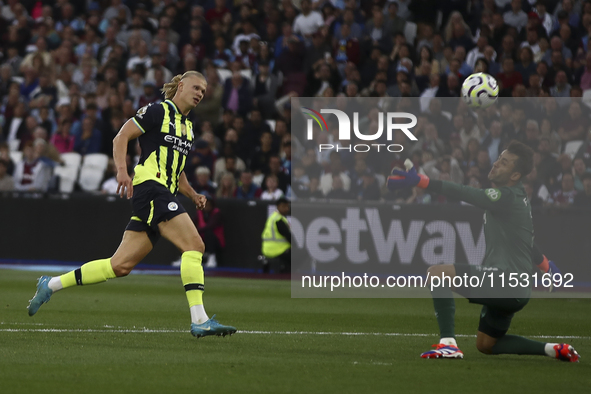 Erling Haaland of Manchester City scores his third goal during the Premier League match between West Ham United and Manchester City at the L...