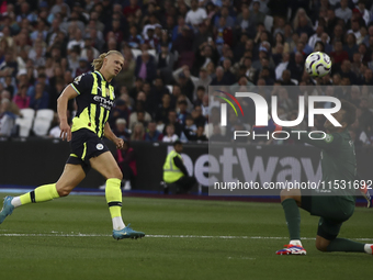 Erling Haaland of Manchester City scores his third goal during the Premier League match between West Ham United and Manchester City at the L...