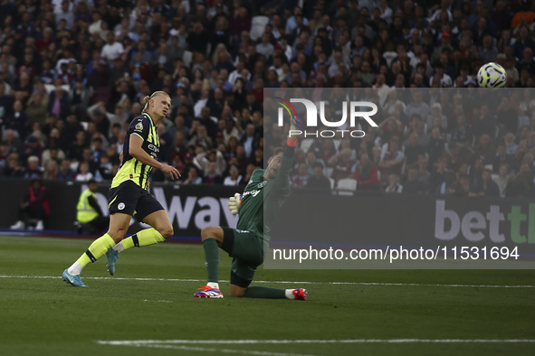 Erling Haaland of Manchester City scores his third goal during the Premier League match between West Ham United and Manchester City at the L...