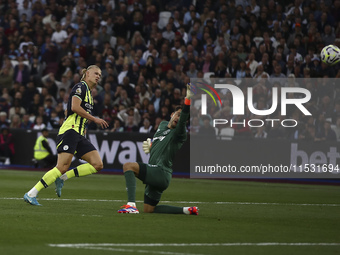 Erling Haaland of Manchester City scores his third goal during the Premier League match between West Ham United and Manchester City at the L...