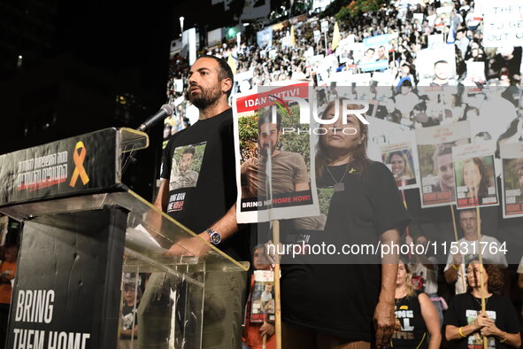 Omri Shtivi, the brother of Idan Shtivi who is held by Hamas in the Gaza Strip, speaks to thousands of Israelis, including the families of h...