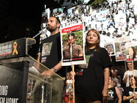 Omri Shtivi, the brother of Idan Shtivi who is held by Hamas in the Gaza Strip, speaks to thousands of Israelis, including the families of h...