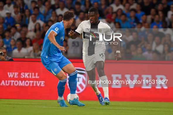 Ange-Yoan Bonny of Parma Calcio competes for the ball with Amir Rrahmani of SSC Napoli during the Serie A match between SSC Napoli and Parma...