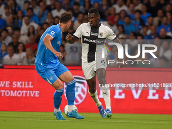 Ange-Yoan Bonny of Parma Calcio competes for the ball with Amir Rrahmani of SSC Napoli during the Serie A match between SSC Napoli and Parma...