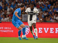 Ange-Yoan Bonny of Parma Calcio competes for the ball with Amir Rrahmani of SSC Napoli during the Serie A match between SSC Napoli and Parma...