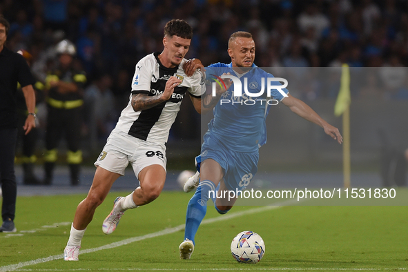 Dennis Man of Parma Calcio competes for the ball with Stanislav Lobotka of SSC Napoli during the Serie A match between SSC Napoli and Parma...