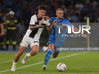 Dennis Man of Parma Calcio competes for the ball with Stanislav Lobotka of SSC Napoli during the Serie A match between SSC Napoli and Parma...