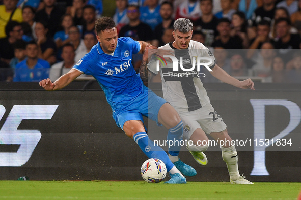 Valentin Mihaila of Parma Calcio competes for the ball with Amir Rrahmani of SSC Napoli during the Serie A match between SSC Napoli and Parm...