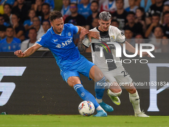 Valentin Mihaila of Parma Calcio competes for the ball with Amir Rrahmani of SSC Napoli during the Serie A match between SSC Napoli and Parm...