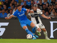 Valentin Mihaila of Parma Calcio competes for the ball with Amir Rrahmani of SSC Napoli during the Serie A match between SSC Napoli and Parm...