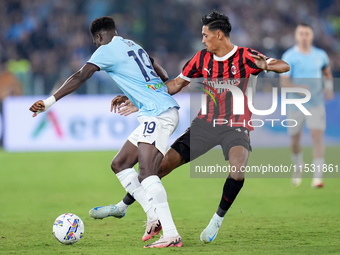 Tijjani Reijnders of AC Milan and Boulaye Dia of SS Lazio compete for the ball during the Serie A Enilive match between SS Lazio and AC Mila...