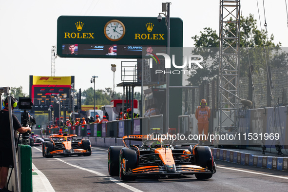 Lando Norris of McLaren and Oscar Piastri of McLaren drive cars during the qualifying session ahead of the Italian Formula One Grand Prix at...