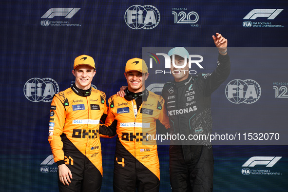 Oscar Piastri of McLaren, Lando Norris of McLaren and George Russell of Mercedes pose after qualifying session ahead of the Italian Formula...