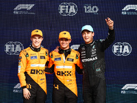 Oscar Piastri of McLaren, Lando Norris of McLaren and George Russell of Mercedes pose after qualifying session ahead of the Italian Formula...