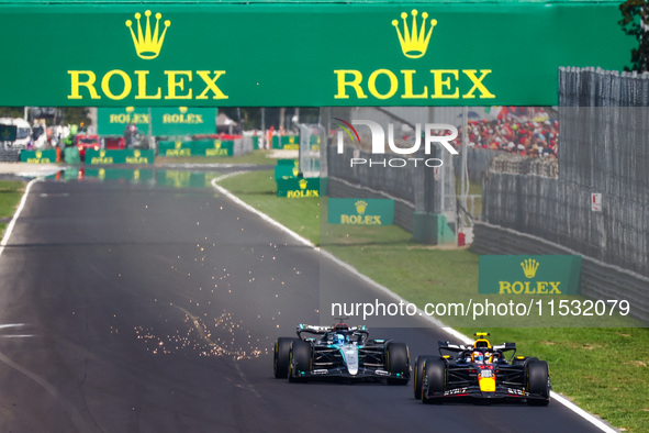 Sergio Perez of Red Bull Racing and George Russell of Mercedes drive on the track during the third practice session, ahead of the Italian Fo...